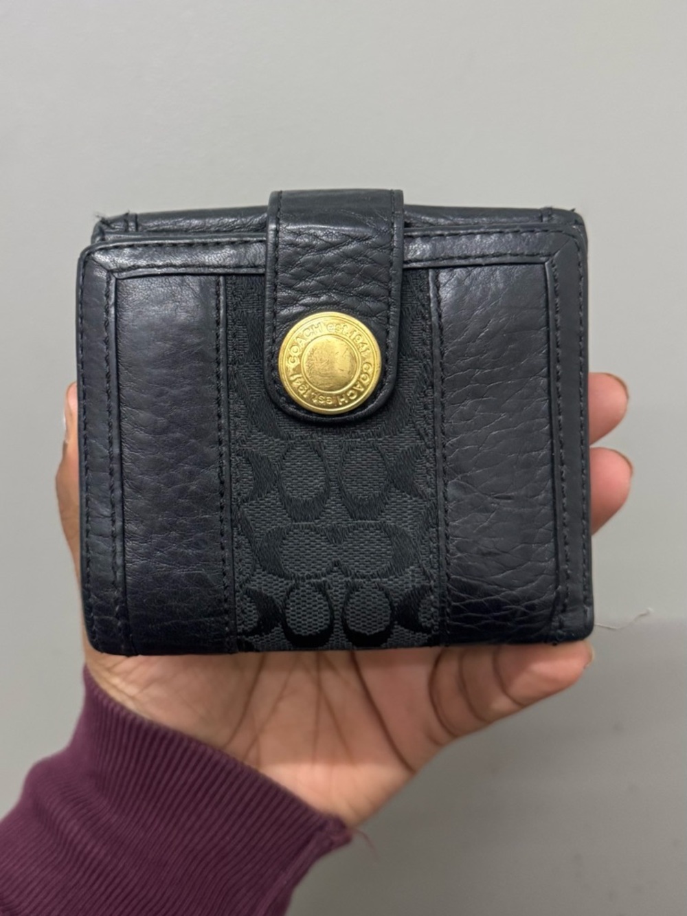 COACH Authentic Black Signature
Jacquard Monogram Trifold
Leather Wallet.